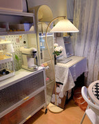 Pleated floor lamp shown against a soft neutral background