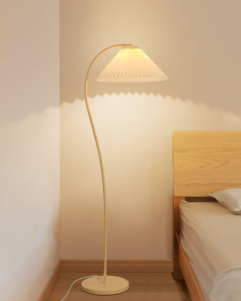 Pleated floor lamp shown full height in a studio setting