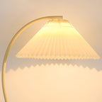 Floor lamp with pleated beige shade in a neutral interior