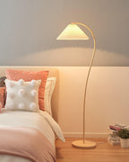 Pleated linen floor lamp glowing in a relaxed reading nook
