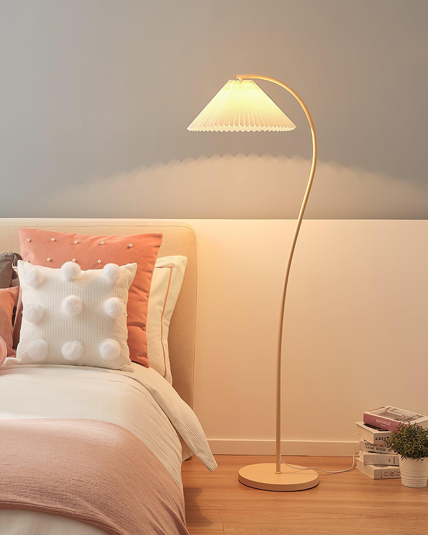 Pleated linen floor lamp glowing in a relaxed reading nook
