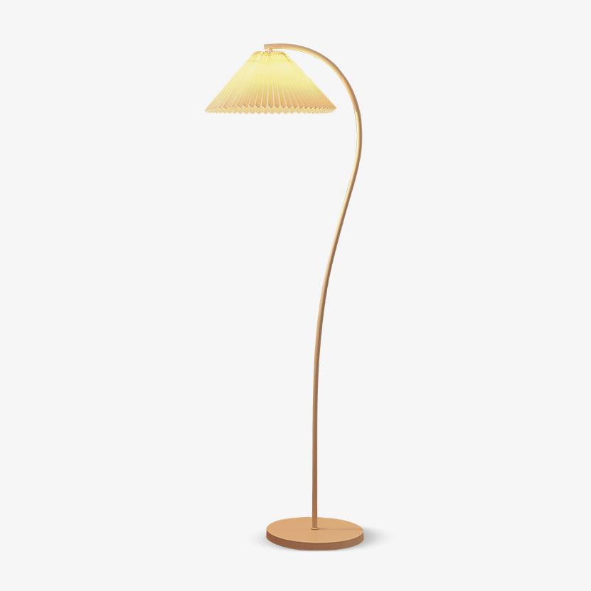 Pleated linen floor lamp lit in a cosy home setting