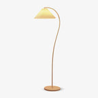 Pleated linen floor lamp lit in a cosy home setting