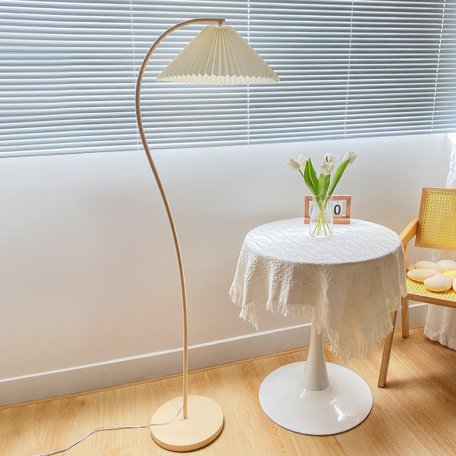 Floor lamp with pleated shade shown against a plain backdrop