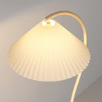 Pleated floor lamp standing tall in a styled living room