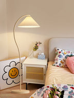 Pleated linen floor lamp glowing in a relaxed home scene