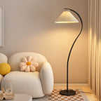 Pleated floor lamp standing tall beside a chair in a living room