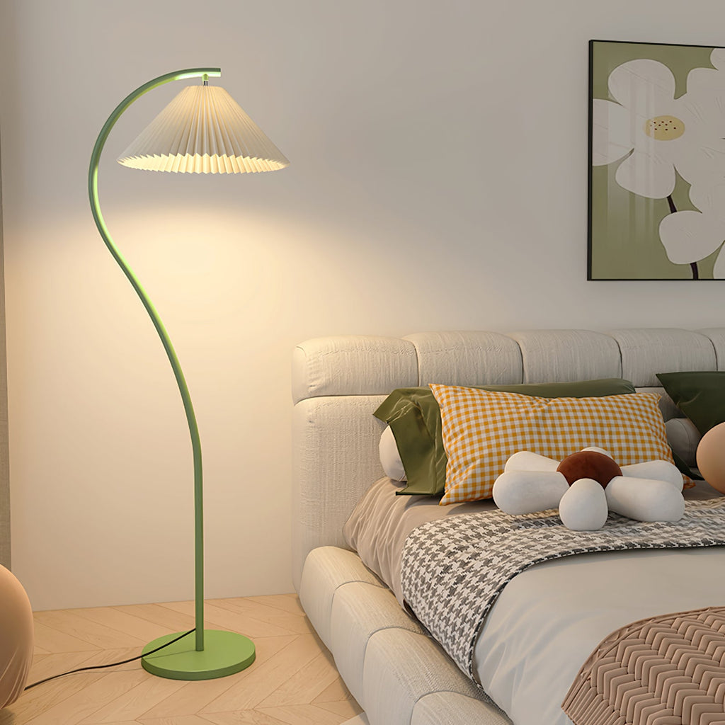 Warm glow from the pleated linen shade of the floor lamp at dusk