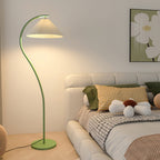 Warm glow from the pleated linen shade of the floor lamp at dusk