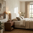 Flanking the bed, two brass Clérachic wall sconces glow softly above matching walnut nightstands.