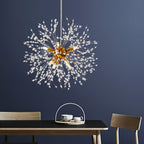 This Clérachic chandelier hangs above a wood dining table set with a teacup, framed by a deep navy wall.