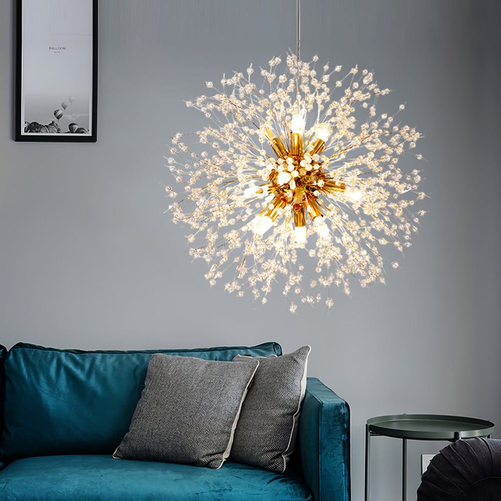A teal velvet sofa with grey cushions sits beneath this Clérachic chandelier against a plain grey wall.