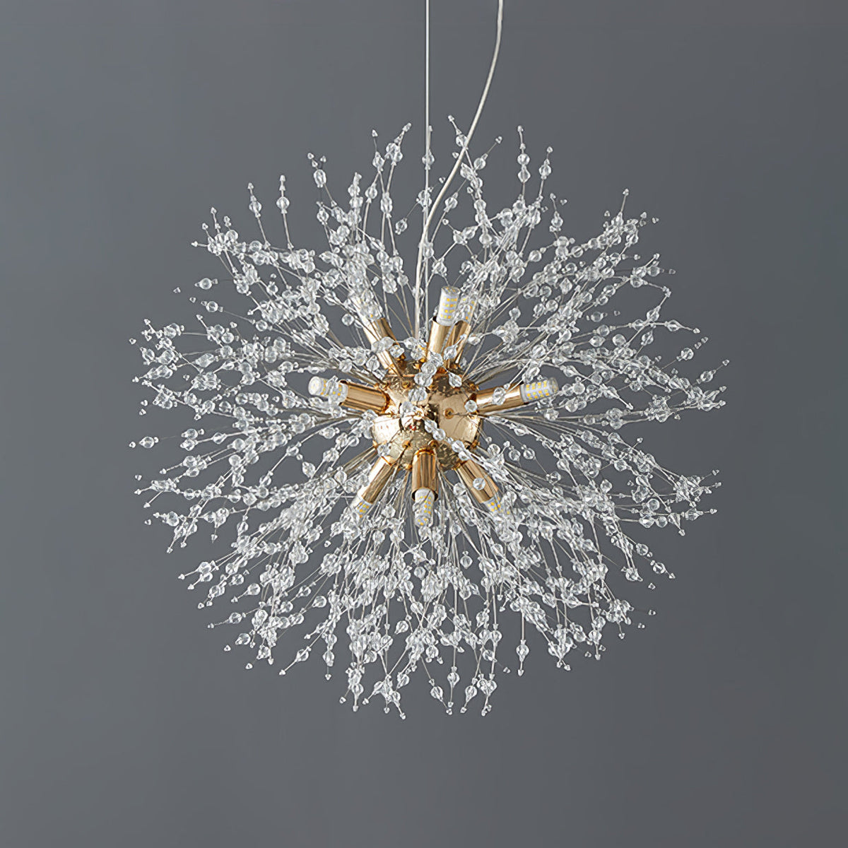 Product shot of this Clérachic chandelier in a chrome finish against a dark charcoal backdrop, its cord fully visible.