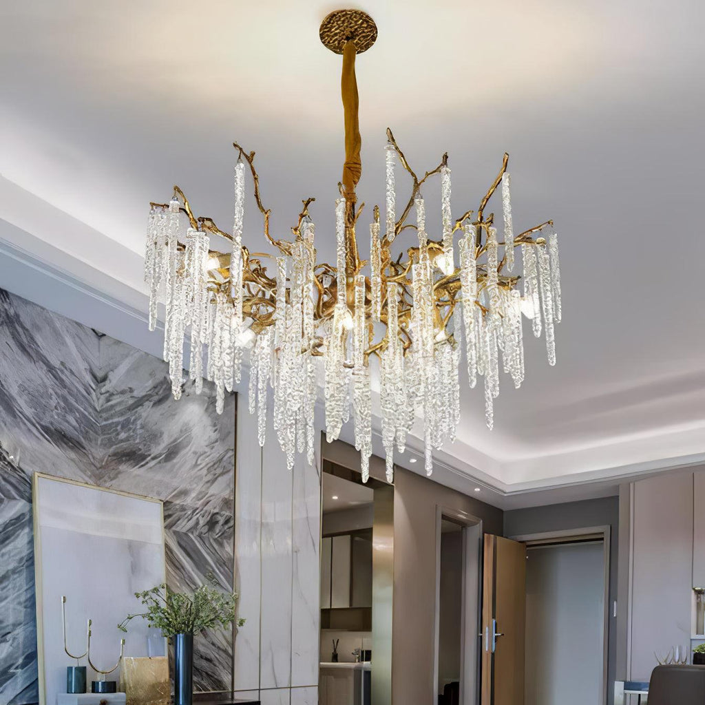 The chandelier lit in a hallway, its glass icicles reflected in a marble-clad wall.