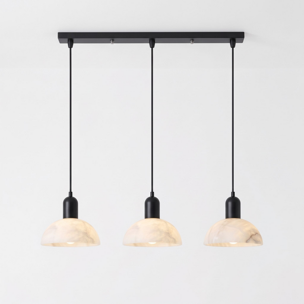 In matte black, this Clérachic pendant shows its three domed alabaster shades strung from a straight bar.