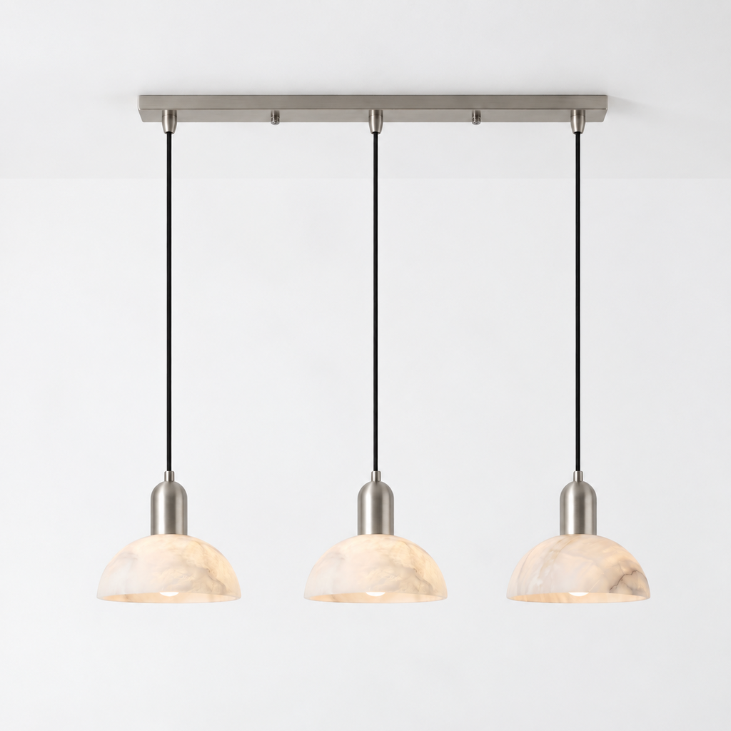 In brushed nickel against white, this Clérachic pendant shows its bar mount and three hanging domes.