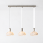 In brushed nickel against white, this Clérachic pendant shows its bar mount and three hanging domes.