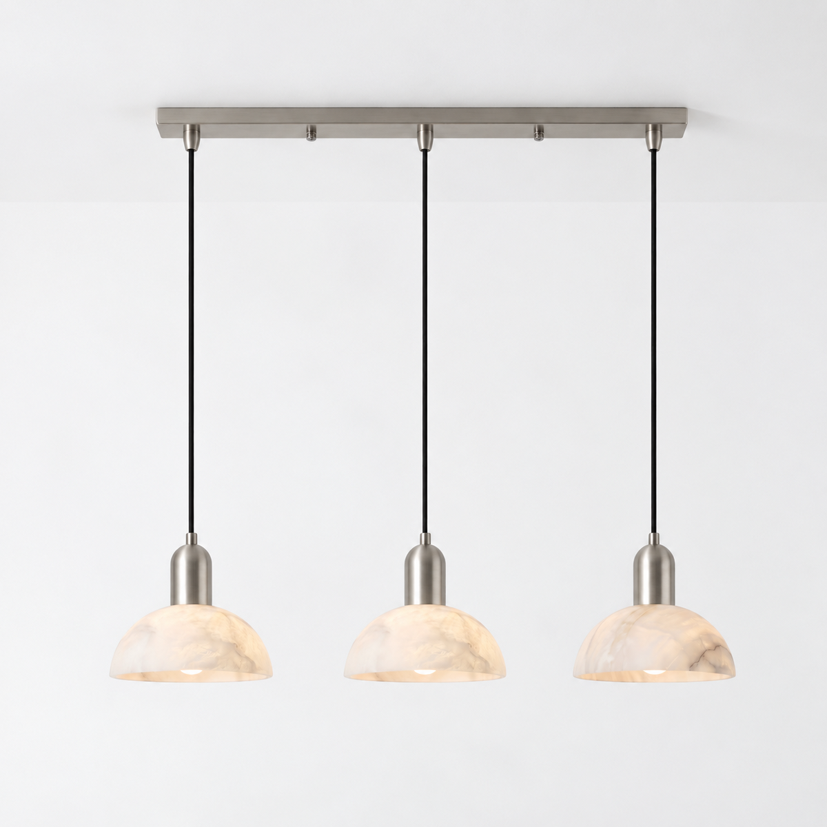 In brushed nickel against white, this Clérachic pendant shows its bar mount and three hanging domes.