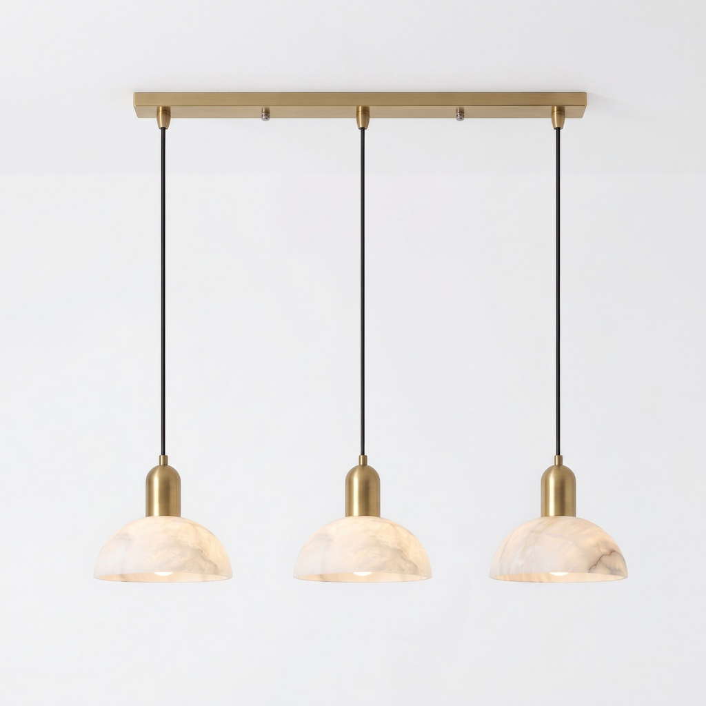 Seen in full against white, this brass Clérachic pendant fans three alabaster domes from a linear bar.