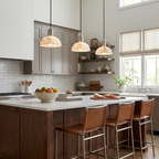 Beside open shelving, this nickel Clérachic pendant lights a kitchen island edged in rust-leather stools.