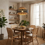 Round table, woven rattan chairs and open shelving surround this lit Clérachic pendant in a bright kitchen nook.