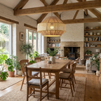 Beneath exposed wood beams, this Clérachic pendant lights a long dining table near an open brick fireplace.