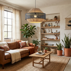 In black rattan, this Clérachic pendant lights a cosy living room with a leather sofa and open shelves.