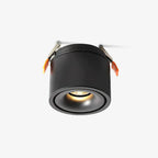 Product shot of this Clérachic downlight in black, its spring-clip mounts extended, glowing warm against a plain white backdrop.