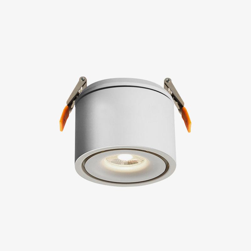 Product shot of this Clérachic downlight in white, its spring-clip mounts extended, lens lit, on a plain backdrop.