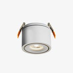 Product shot of this Clérachic downlight in white, its spring-clip mounts extended, lens lit, on a plain backdrop.