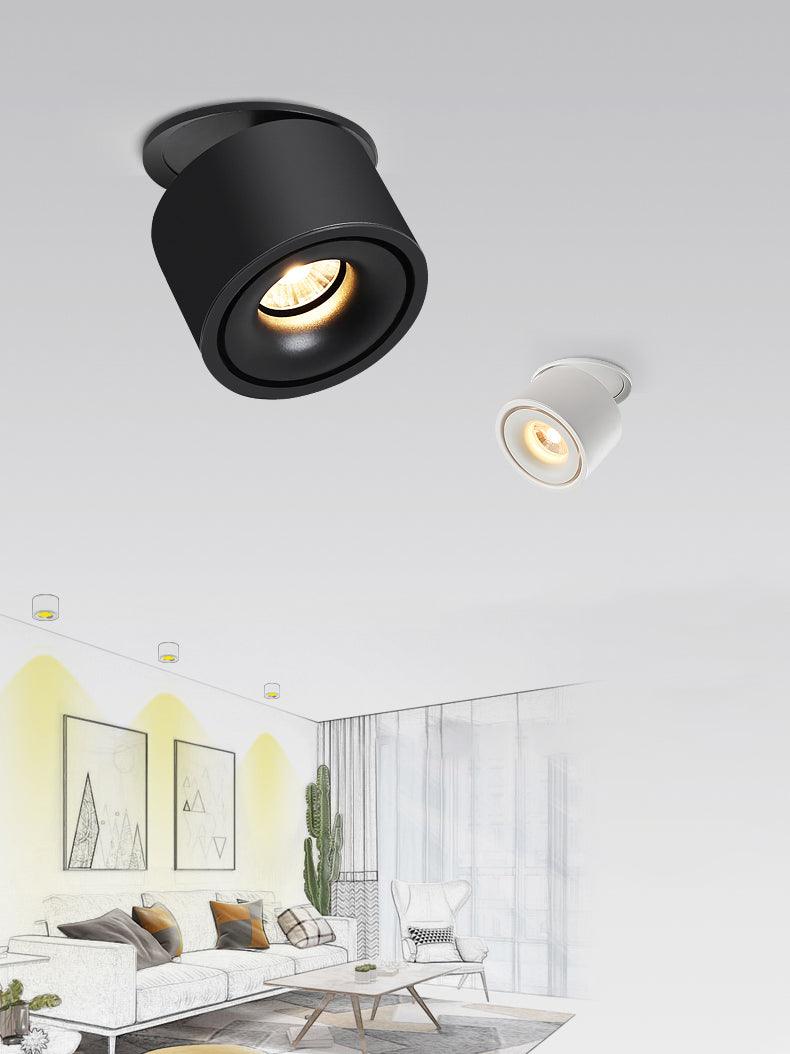Close view of this Clérachic downlight in black, angled on a ceiling, with its white version shown small beside a sketched living room.