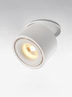Close view of this Clérachic downlight in white, angled forward, its lens glowing warm against a plain backdrop.