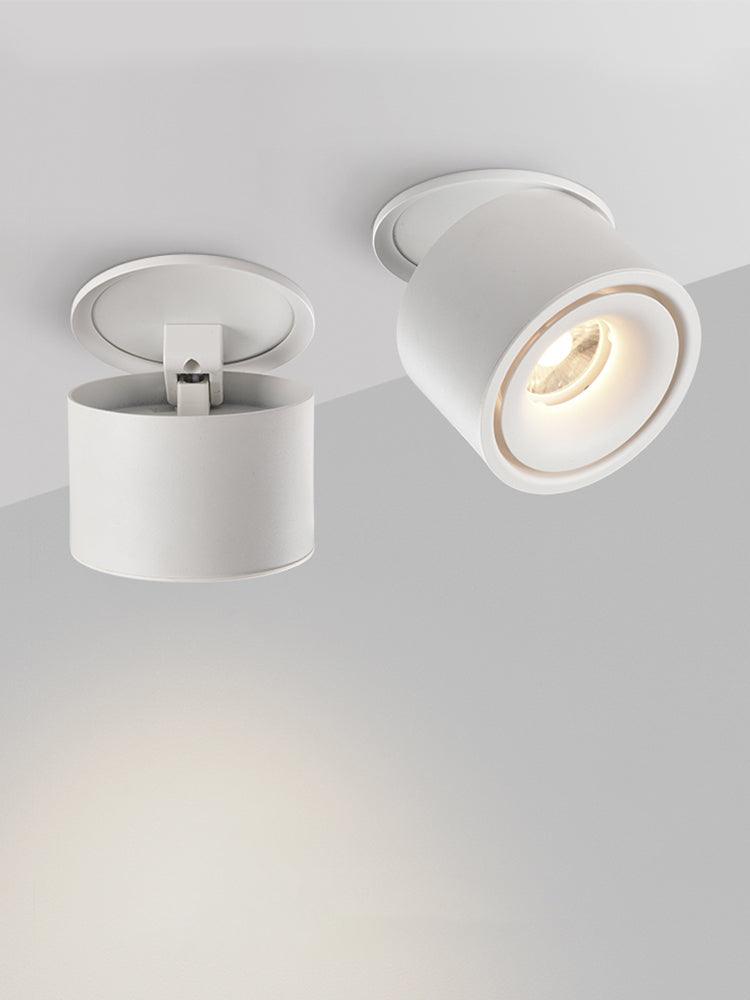 Two views of this Clérachic downlight in white, one showing its open mounting ring, the other angled and lit.