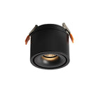 Product shot of this Clérachic downlight in black, angled, its spring-clip mounts extended against a plain white backdrop.