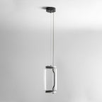 Studio shot of this Clérachic pendant's single small cylinder hanging from a long cord against a plain backdrop.