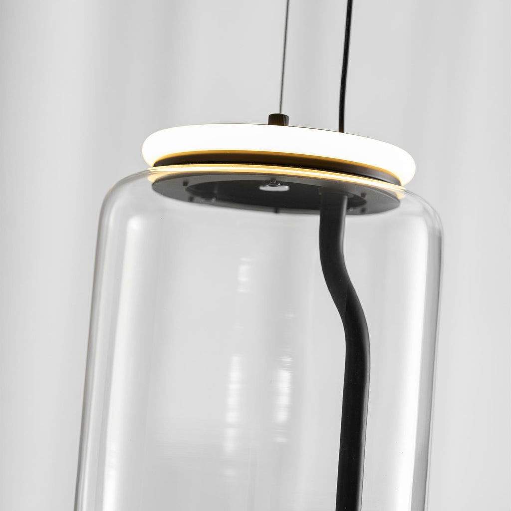 Looking up inside this Clérachic pendant's glass cylinder at its glowing LED ring and black internal cord.
