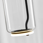 Close view from below of this Clérachic pendant's glass cylinder, its LED ring glowing warm at the base.