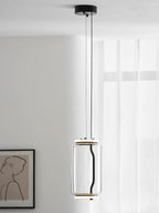 A single wide-cylinder Clérachic pendant hangs in a white room beside a line-drawn portrait print.
