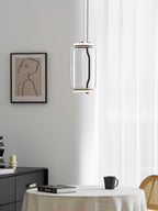 A single wide-cylinder Clérachic pendant hangs near a sheer curtain and a framed portrait print.