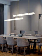Linear pendant light in black finish over a dining setting