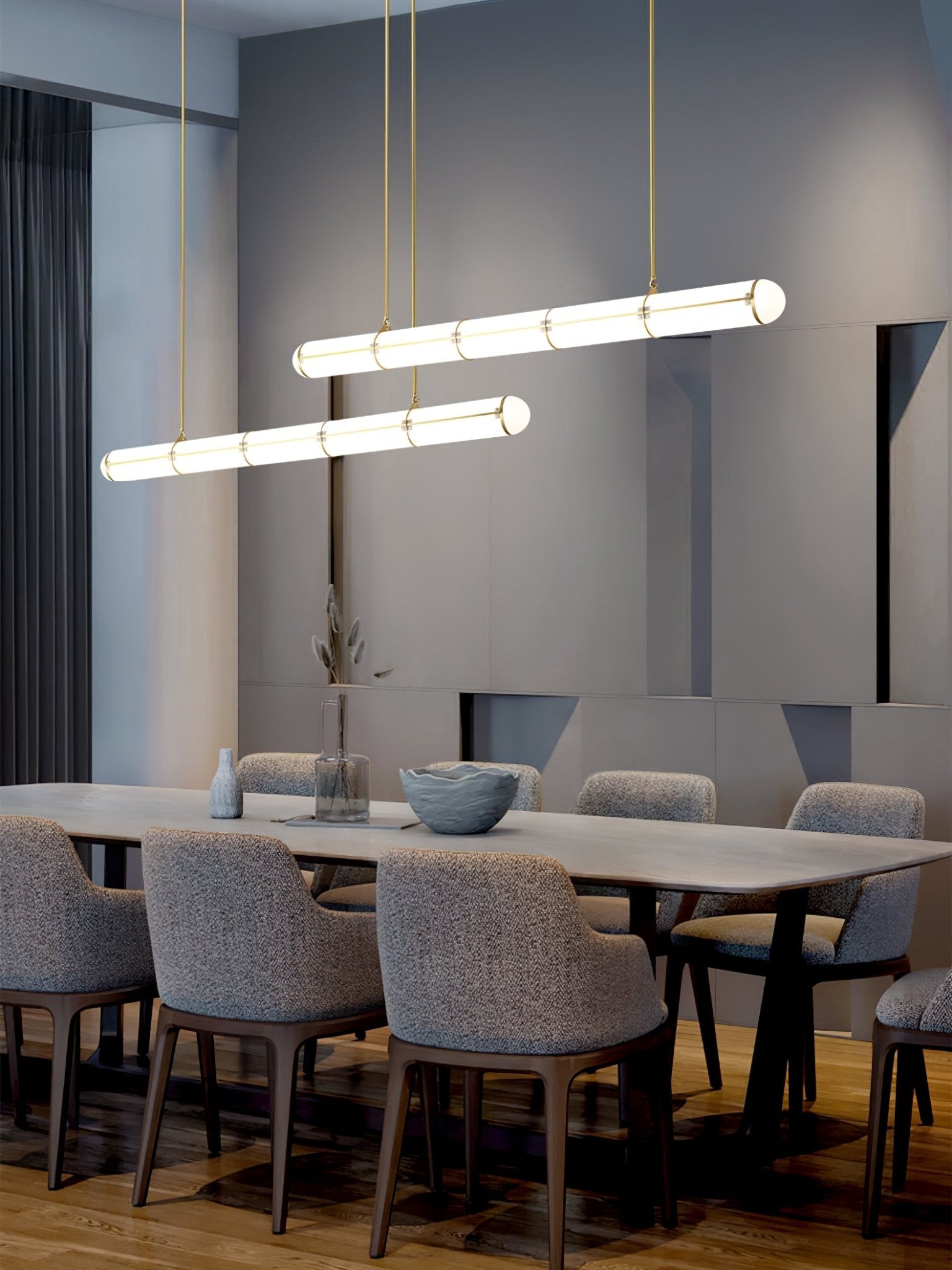 Linear pendant light in black finish over a dining setting