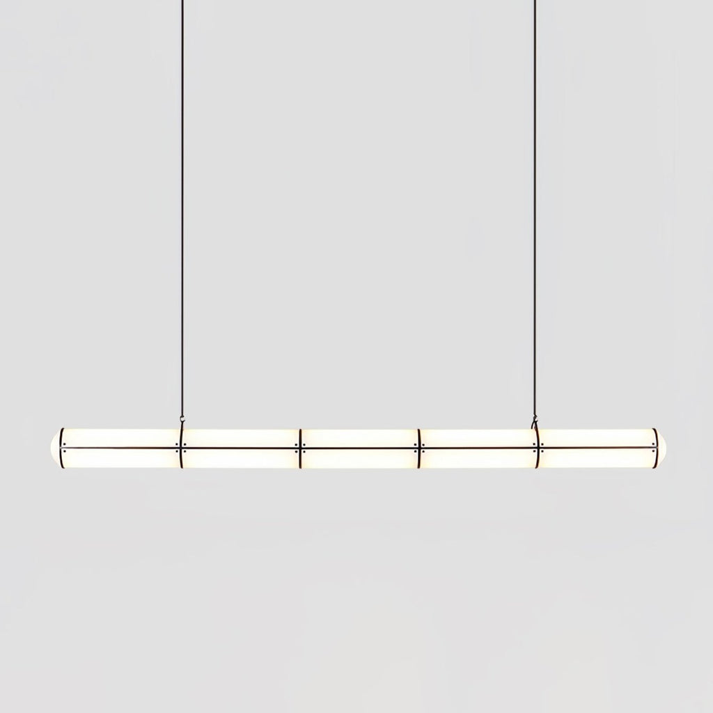 Linear pendant light in gold finish hanging in an interior