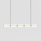 Linear pendant light in gold finish hanging in an interior
