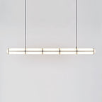 Linear pendant light shown in a minimal architectural room