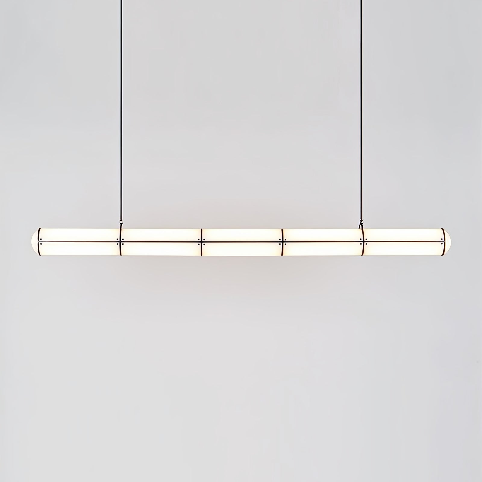 Linear pendant light shown in a minimal architectural room