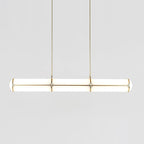 Linear pendant light shown lit in a modern room