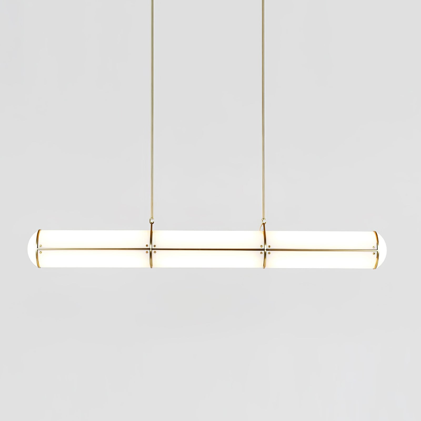 Linear pendant light shown lit in a modern room