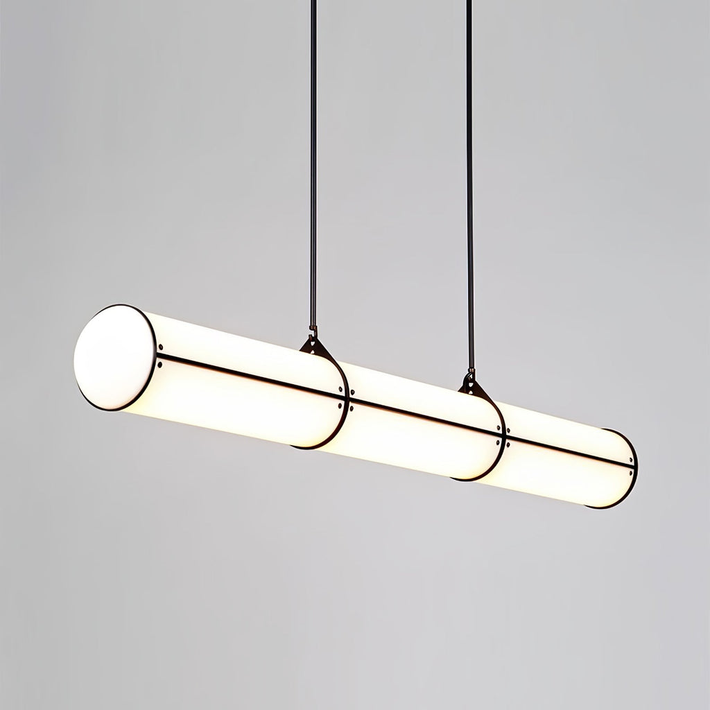 Linear pendant light glowing above a styled table