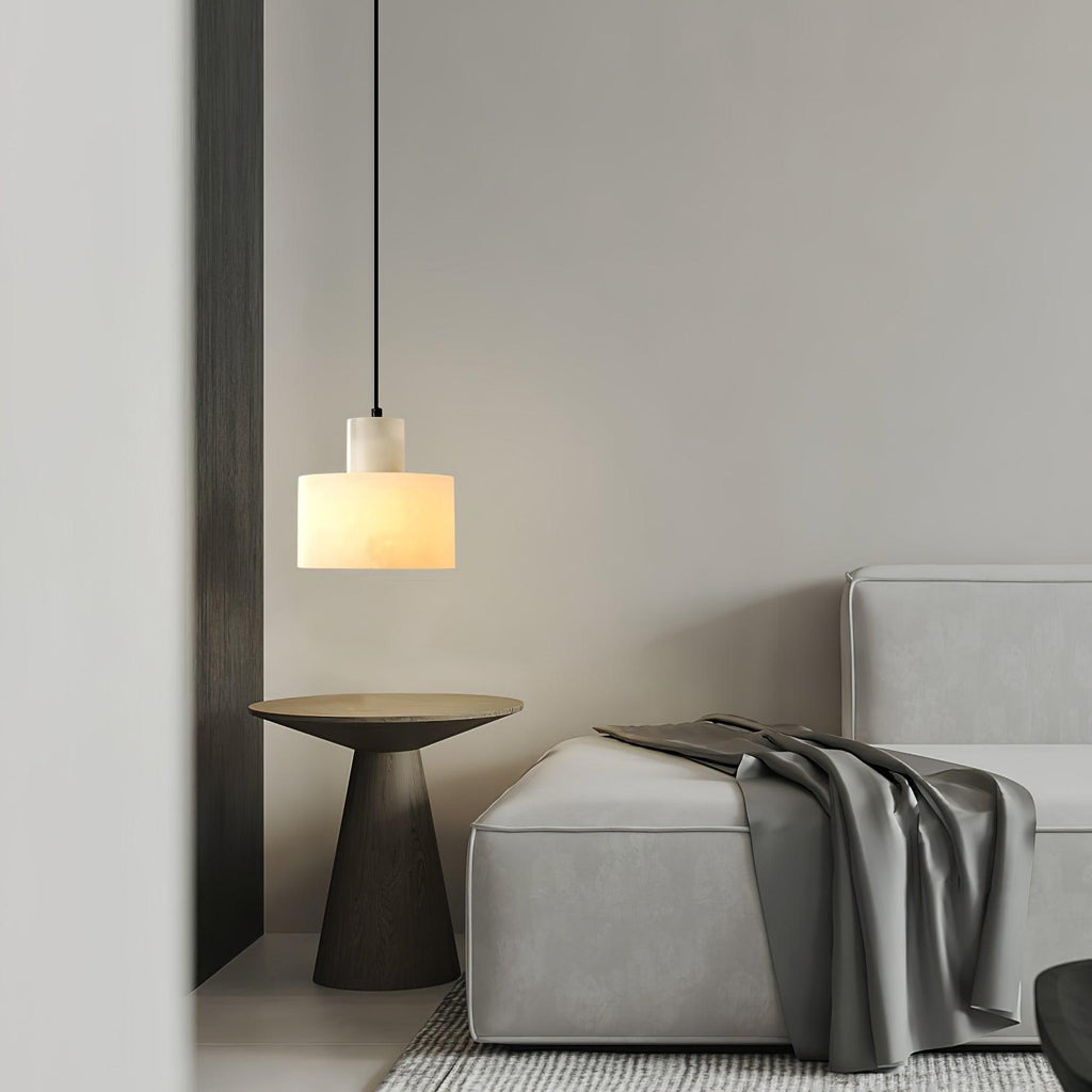Alabaster pendant light glowing warmly above a console