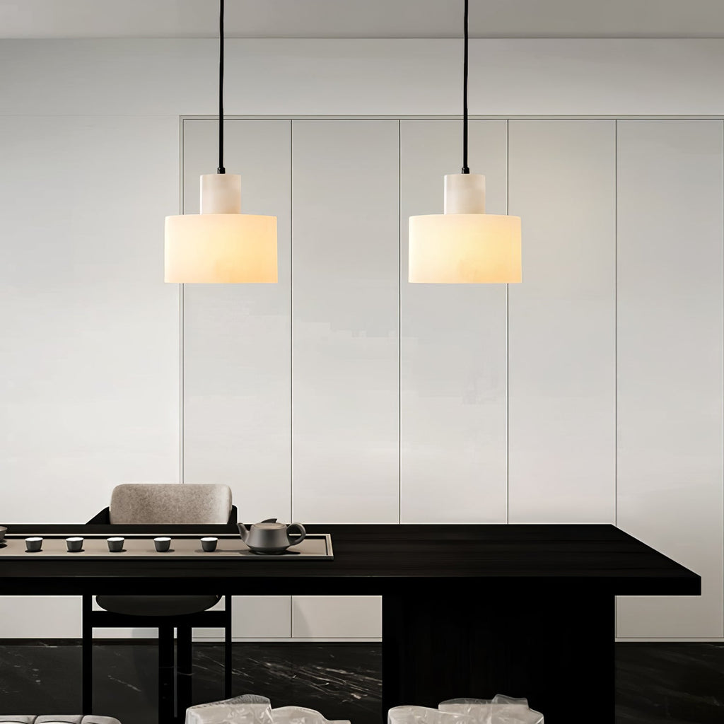 Warm stone glow from the alabaster pendant in a bedroom